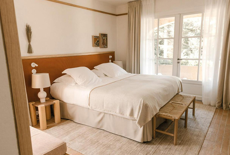 Luxury hotel beds, hotel chairs, and bedside tables